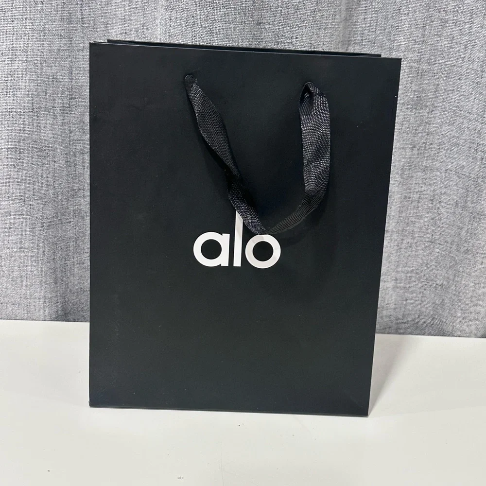 ALO black and white, empty paper bag with tissue paper and holiday gift charm. - Picture 4 of 5